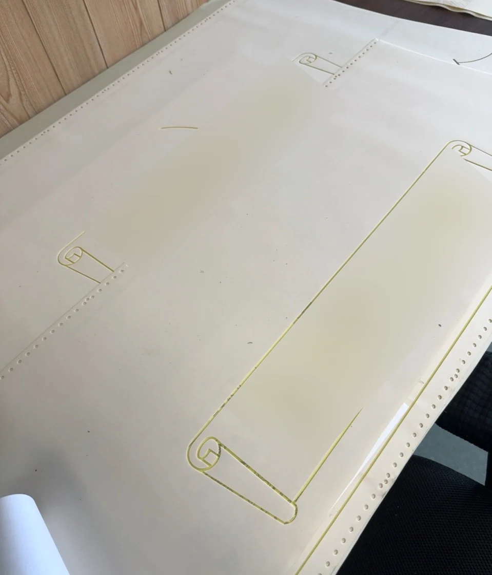 Cut monument stencils with scroll borders; customer lettering blurred